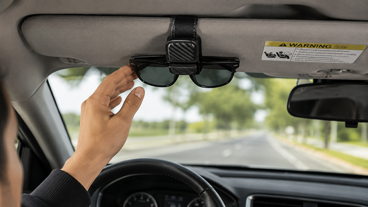 Sunglasses stored securely in a compact car sun visor holder